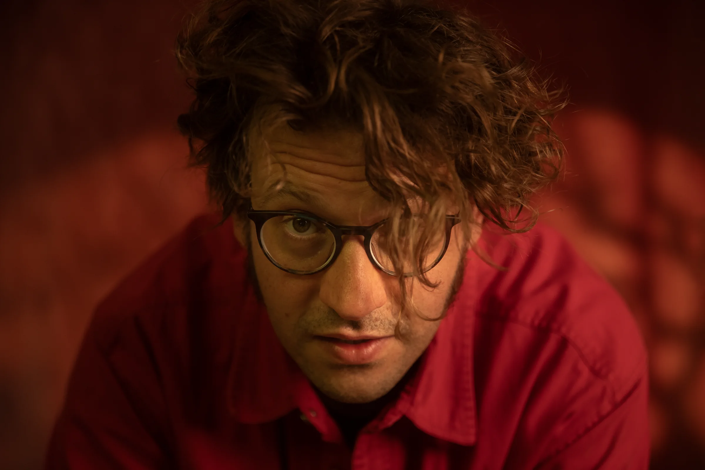 Harvey Pink in red light with patterned shadows